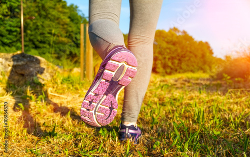 Woman running at sunset in a field