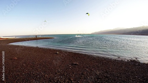 Person Involved Kitesurf Jumping Over the Water Using Parachute