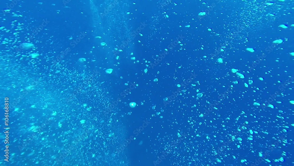 Many White Air Bubbles in the Clear Blue Sea Water Many White Air Bubbles in the Clear Blue Sea Water