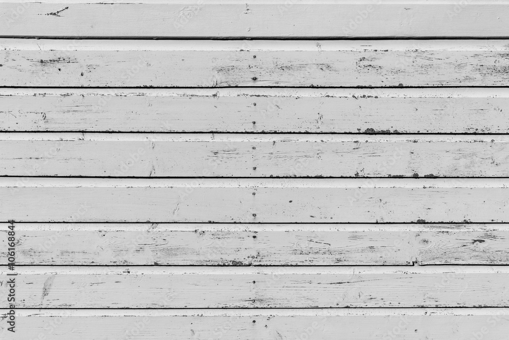 Section of weathered white wood panelling from a beach hut, suitable for backgrounds of beach, seaside and summer holiday themes. Section of weathered white wood panelling from a beach hut, suitable for backgrounds of beach, seaside and summer holiday themes.