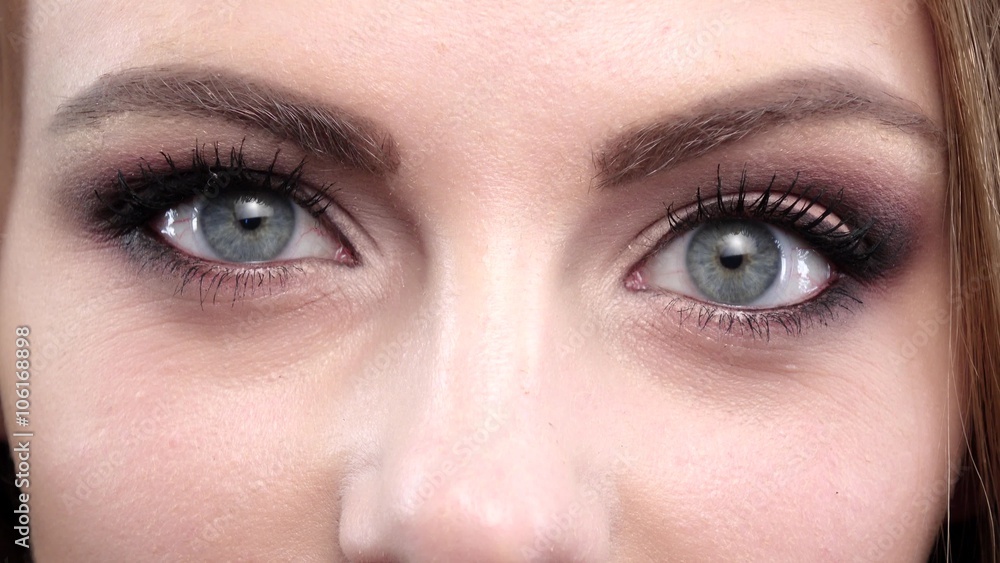 Woman winking. Blue eyes. Closeup Woman winking. Blue eyes. Closeup