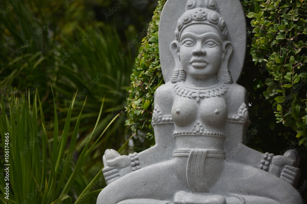 buddha statue seating in the park and meditating buddha statue seating in the park and meditating