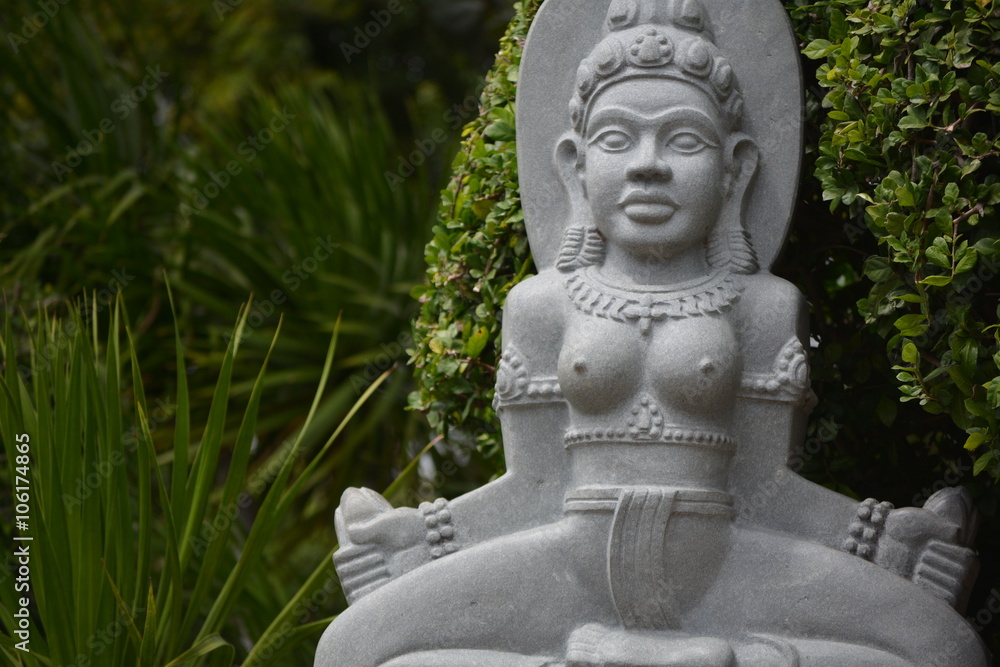 buddha statue seating in the park and meditating