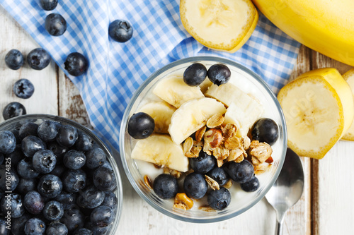 Yogurt with homemade granola, banana and blueberries. Healthy br