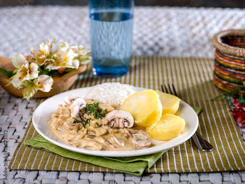 Chicken a La King with potatoes and rice
