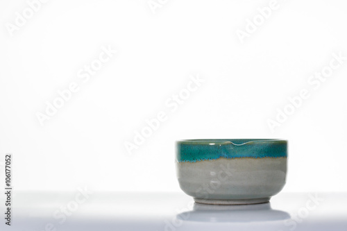 Asian ceramics cups on white with reflection