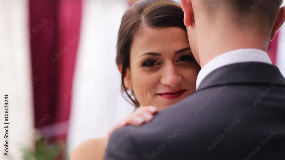 Happy bride and groom romantically hugging each other and pose on camera. Happy bride and groom romantically hugging each other and pose on camera.