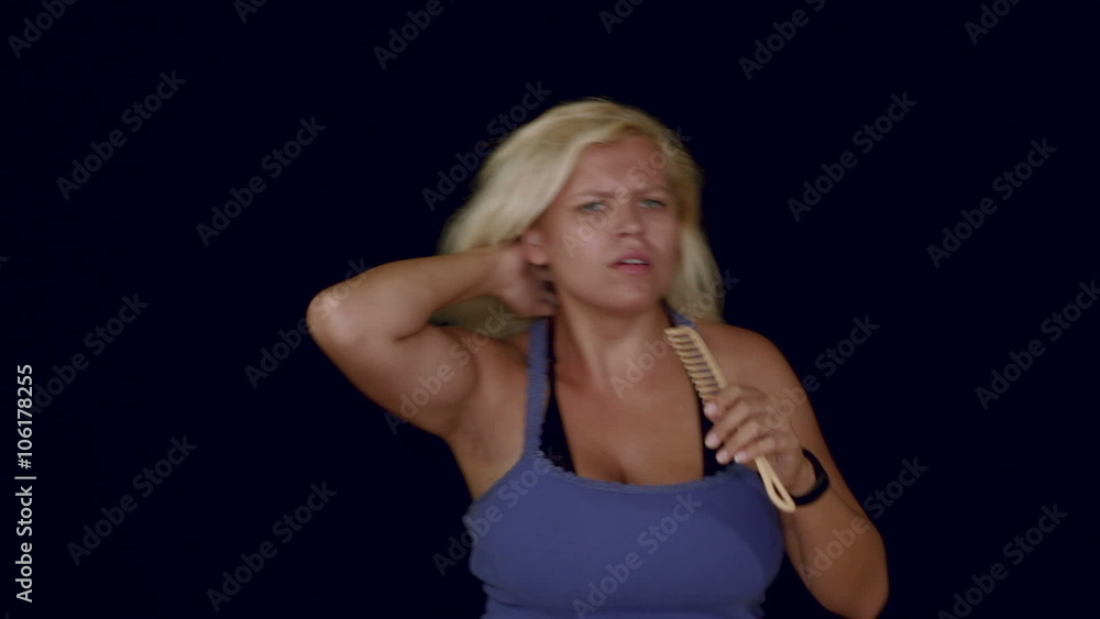 Funny blond woman dancing and singing with comb, studio isolated. Funny blond woman dancing and singing with comb, studio isolated.