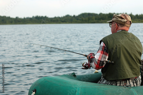 Spinning fisherman on a boat fishing