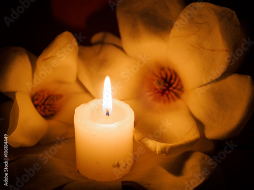 Lit candle with flower