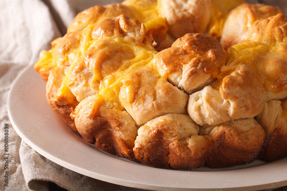 Homemade monkey bread with cheese macro on a plate. horizontal
Homemade monkey bread with cheese macro on a plate. horizontal