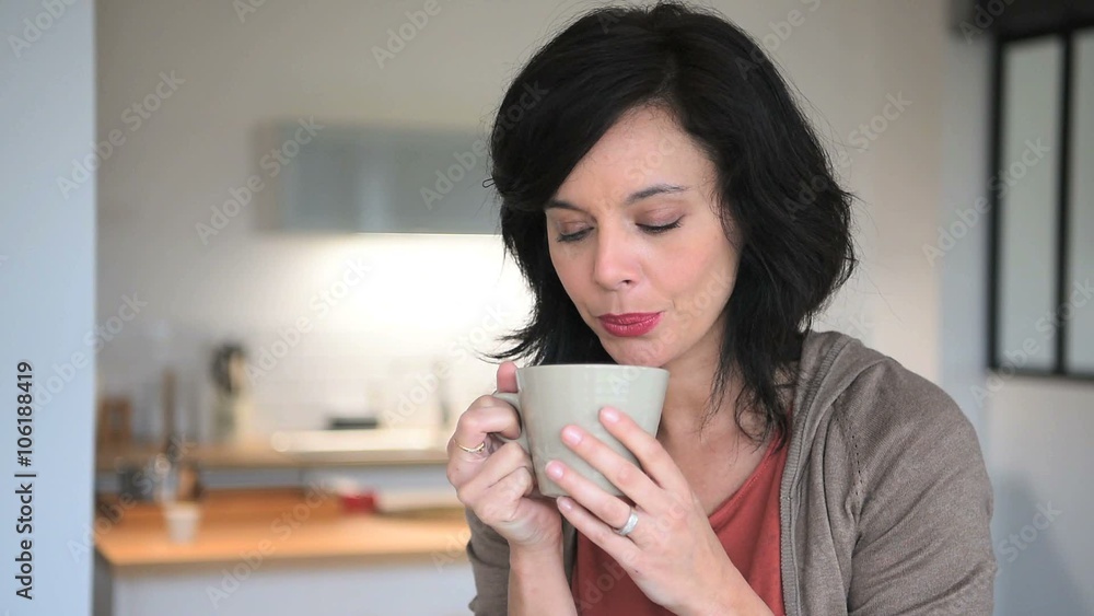 Smiling mature woman at home drinking tea Smiling mature woman at home drinking tea