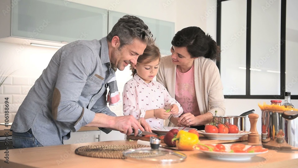Parents with child cooking together at home Parents with child cooking together at home