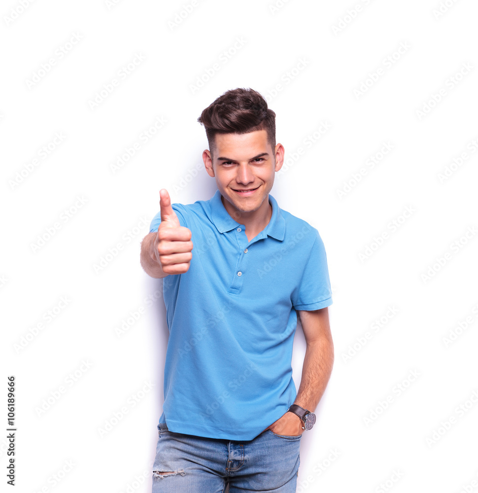 boy in blue polo shirt showing thums up sign boy in blue polo shirt showing thums up sign
