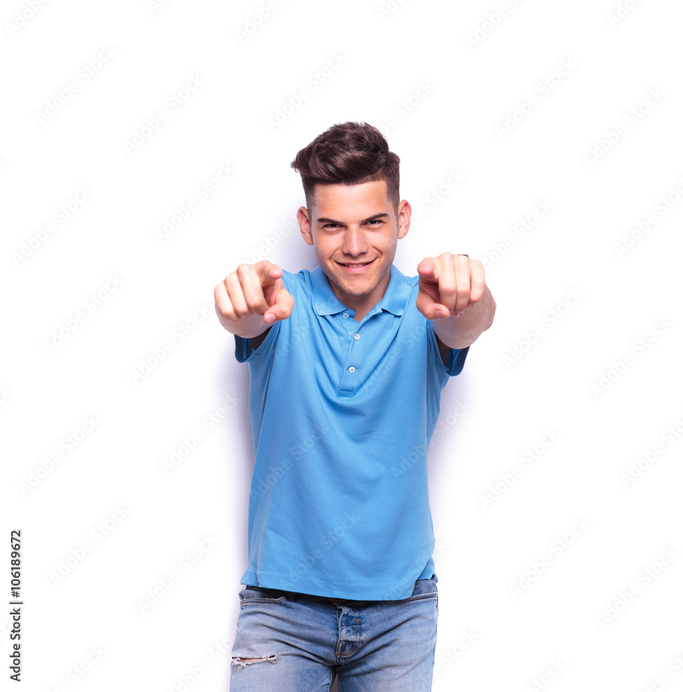 young man in polo shirt pointing fingers young man in polo shirt pointing fingers