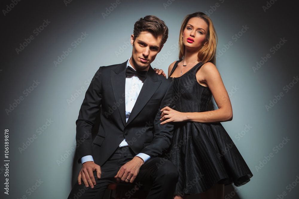 elegant couple in black posing in studio