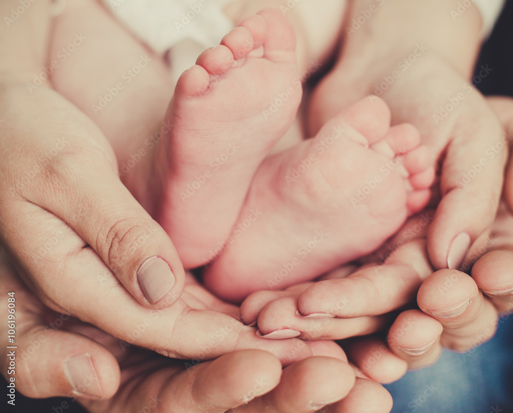 little feet in the hands of parents little feet in the hands of parents