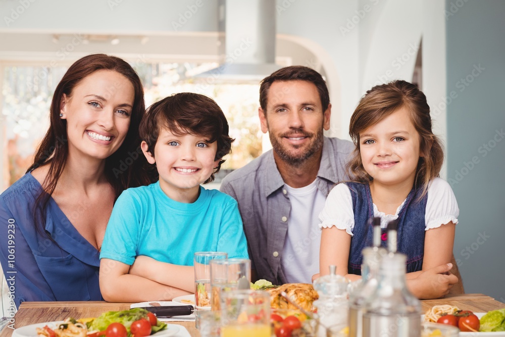Portrait of cheerful family with food on dining table Portrait of cheerful family with food on dining table