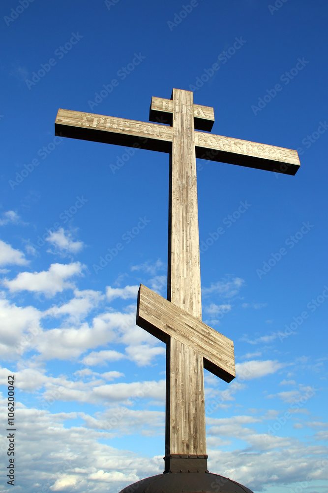 Wooden cross on the background of the sky
