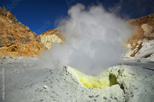 Fumarole inside the crater of active volcano produces smelly fog photo