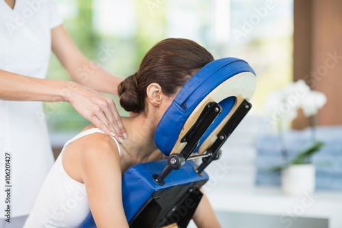 Young woman receiving back massage