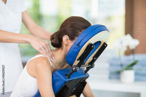 Young woman receiving back massage photo
