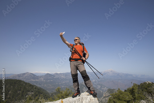 Hiker taking selfie on top of the mountain.