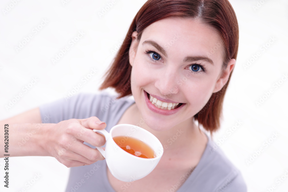 woman holding cup of  tea
