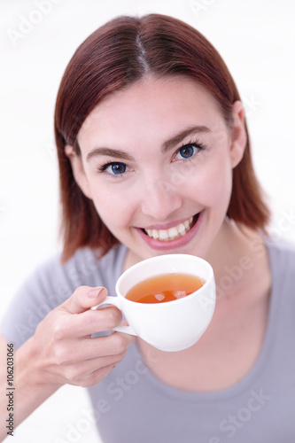 woman holding cup of tea