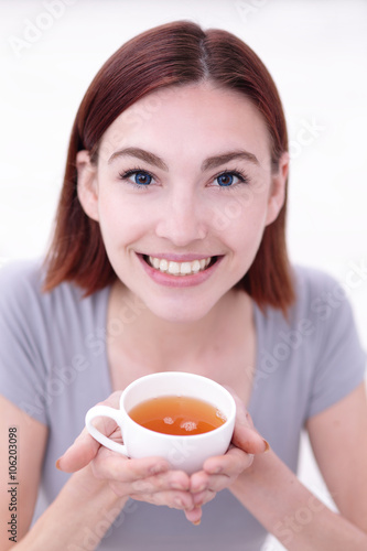 woman holding cup of tea