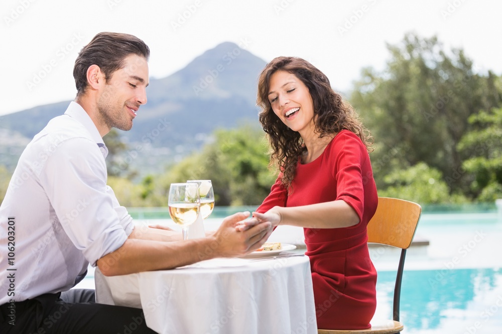 Couple looking at engagement ring Couple looking at engagement ring
