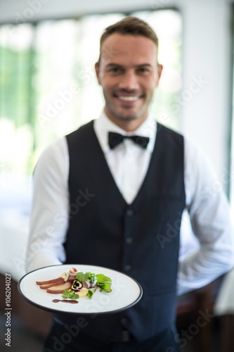 Waiter showing a dish