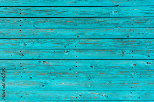 Section of textured turquoise wood panelling from a seaside beach hut. Could be used as a background to illustrate beach and summer holiday themes.
 photo