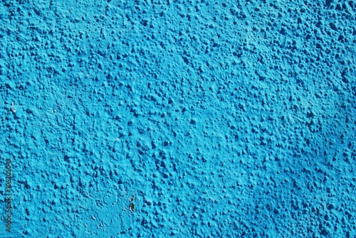 A textured wall in Greece painted in the blue colour of the Greek National flag.