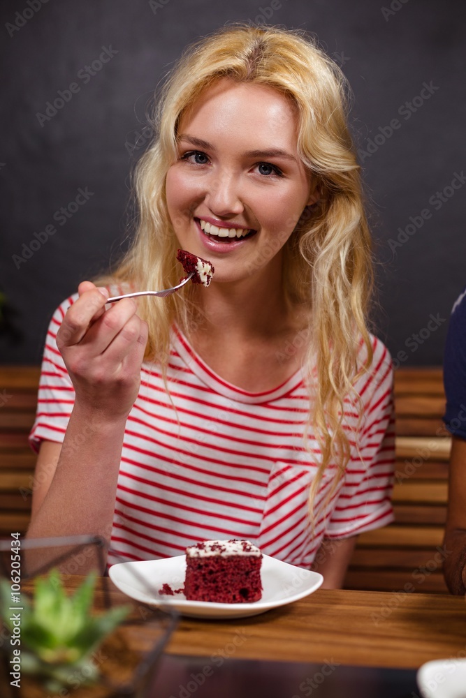 Smiling blonde enjoying a pastry Smiling blonde enjoying a pastry