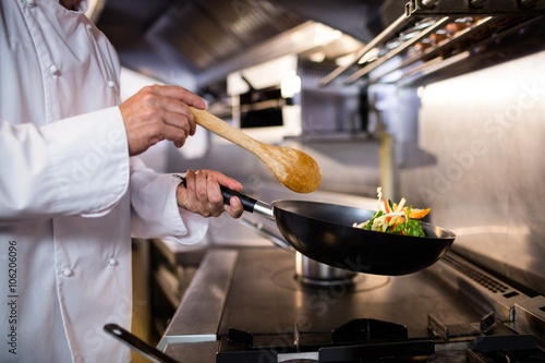 Принти на полотні Chef preparing food in the kitchen