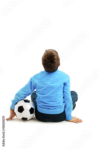 Back view of a child in sportswear with soccer ball. Isolated on white background. Soccer ball  © Jelena Ivanovic
