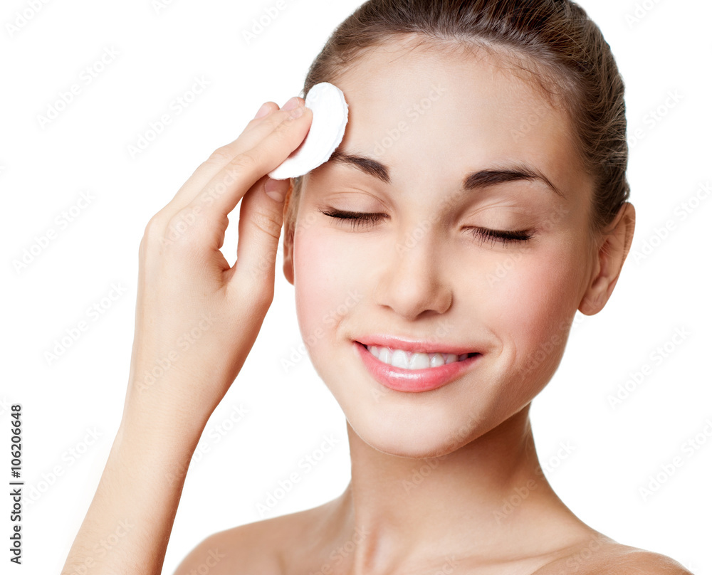 Woman using cotton pad. Happy smiling beautiful young woman clea