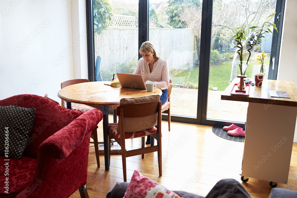 Woman Working From Home On Laptop In Modern Apartment Woman Working From Home On Laptop In Modern Apartment