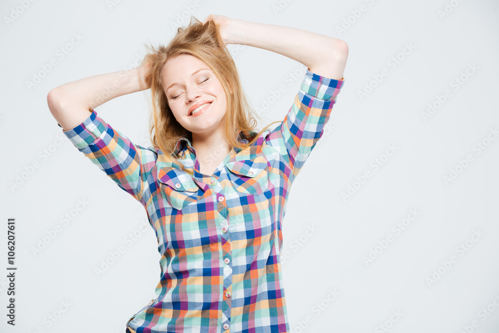 Fototapeta premium Smiling young woman with closed eyes