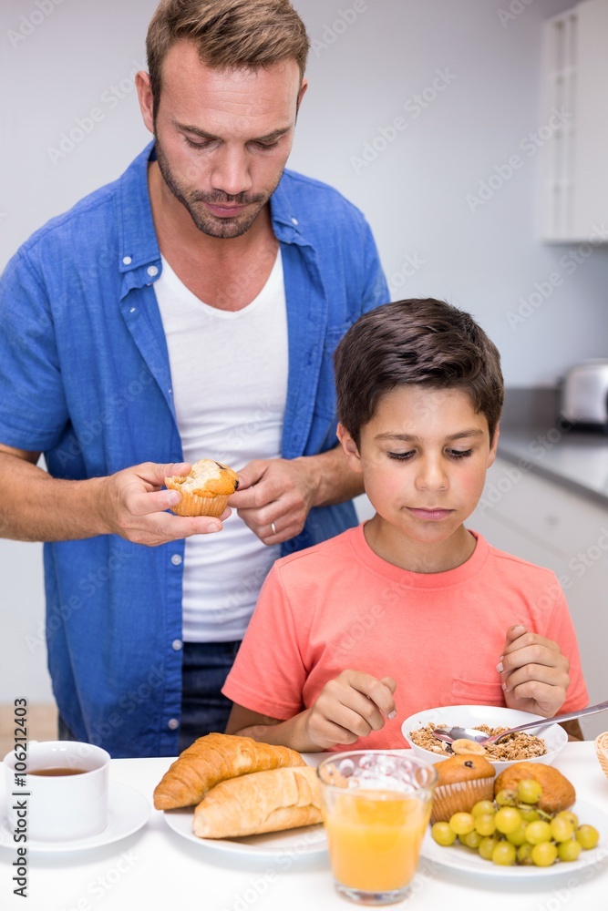 Father and son having breakfast