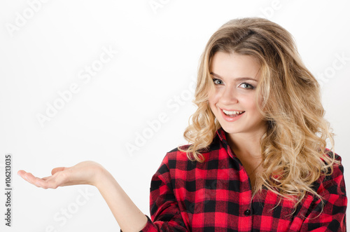 Smiling woman showing open hand palm with copy space for product or text