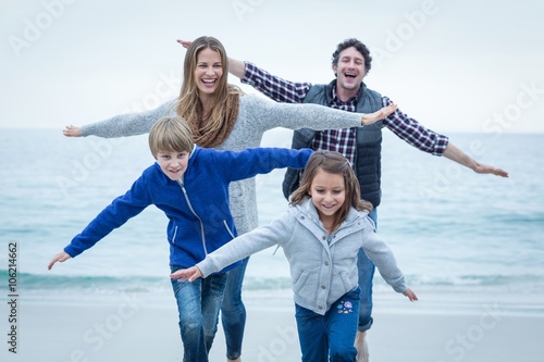 Children enjoying with parents at sea shore