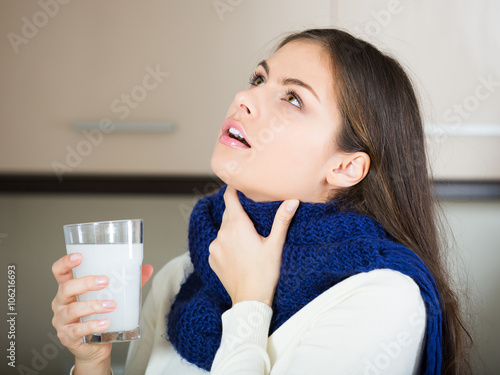 Photos Brunette gargling throat with medicine