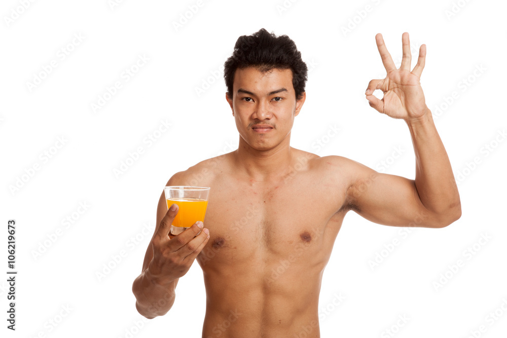 Muscular Asian man show OK with orange juice Muscular Asian man show OK with orange juice