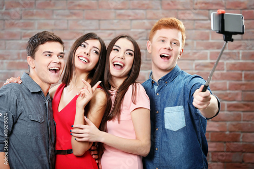 Happy young friends taking ...