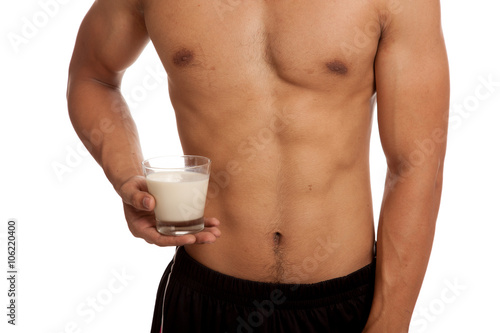 Muscular Asian man show his six pack abs with milk