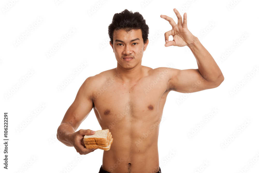 Muscular Asian man load carbs with some bread show OK Muscular Asian man load carbs with some bread show OK