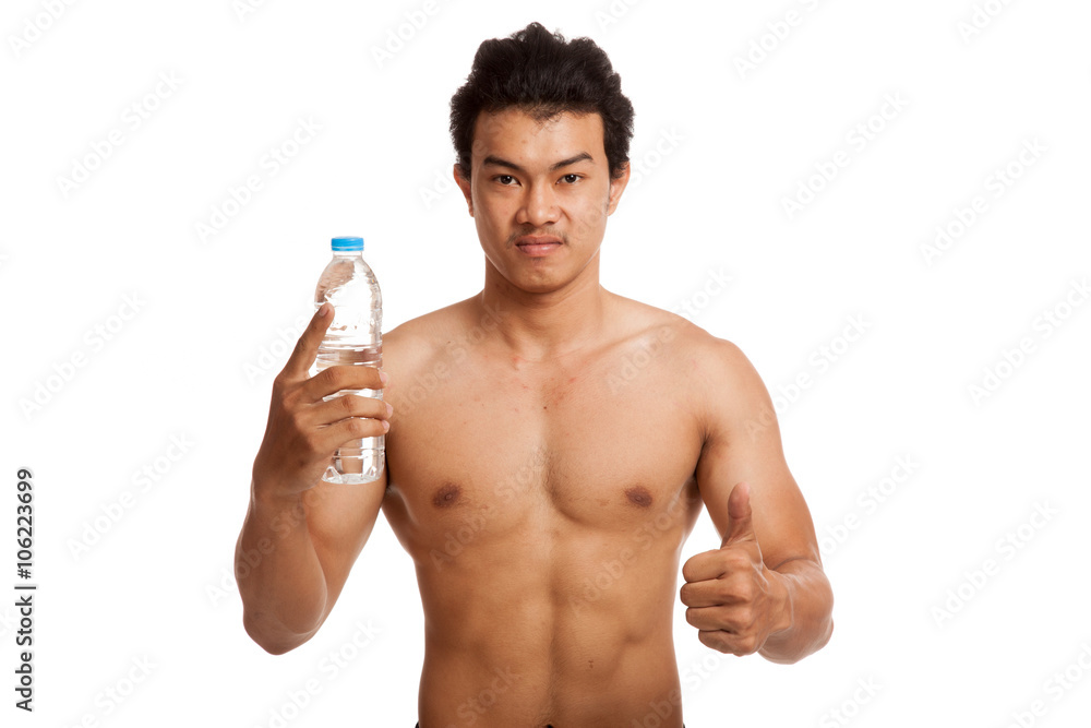 Muscular Asian man thumbs up with bottle of drinking water Muscular Asian man thumbs up with bottle of drinking water