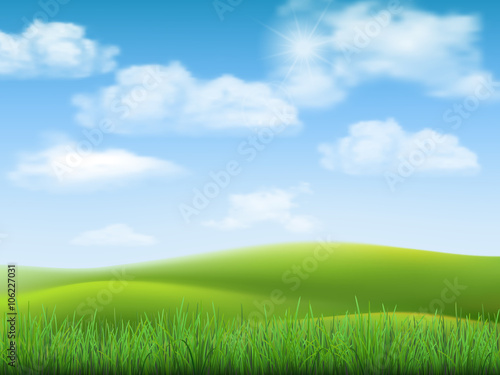 Nature landscape with sky, hills and grass on foreground.